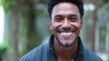 Happy african american man walking portrait, smiling black guy coming forward outdoors