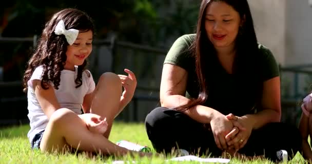 Candid Asian Mother Sitting Grass Daughters Mom Tutoring Girls Study — Video