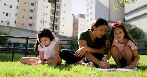 Parent Helping Children Study Park Asian Mother Tutoring Homework Little — Stock Video