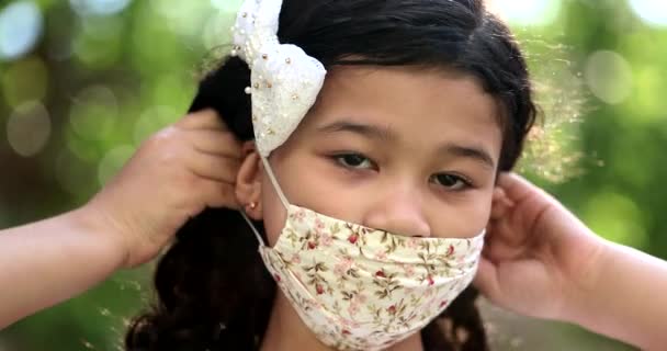 Child Putting Covid Face Mask Looking Camera Portrait — Stockvideo