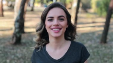 Attractive girl walking in the woods towards camera