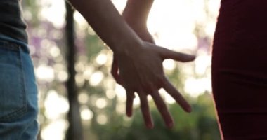 Joining hands together, uniting the chain from hands held together in the sunlight