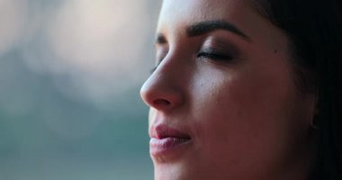 Hispanic latina beautiful young woman closing eyes and taking a deep breath and then opening eyes again