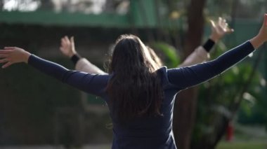 Two female friends hug and embrace. Girlfriends real life happiness reunion outdoors. Friend with arms stretched hugging