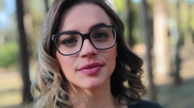 Feminist Girl wearing glasses looking directly to camera
