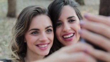 Female friends taking a selfie at park