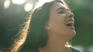 Happy woman laughing and smiling. Person real life spontaneous laugh and smile. 30s girl standing outdoors