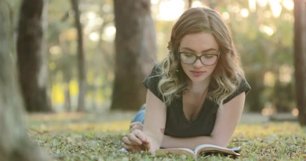 Smart Intelligent Girl Wearing Glasses Lying Grass Park Reading Book — Stockvideo