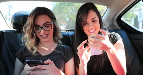 Friends Together Back Seat Taxi Holding Cellphones Checking Messages — Stockvideo