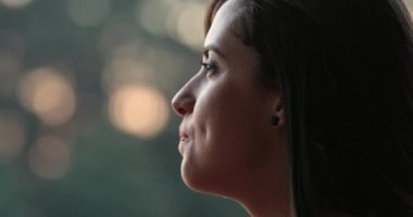 Candid profile of girl speaking with friend off-camera