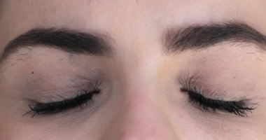 Woman opening eyes. Extreme close-up of girl opens eye