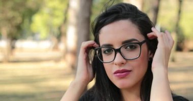 happy woman wearing glasses looking to camera with smiling