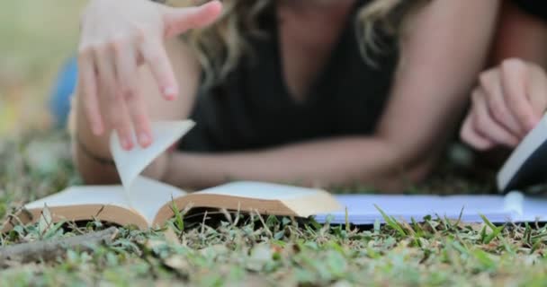 Girl Turning Page Book Lying Grass Outdoors Woman Reading Book — Stockvideo
