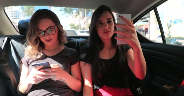 Candid Friends Back Seat Car Checking Cellphone Two Girls Looking — Video Stock