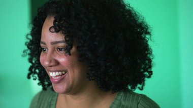 A black woman smiling face closeup with curly hair