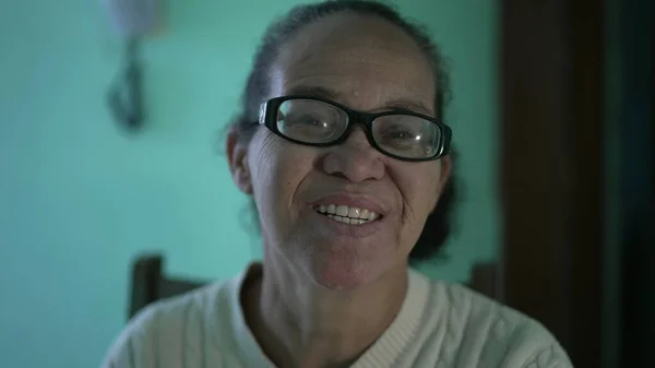 A happy senior hispanic older woman smiling at camera. An older south american person portrait