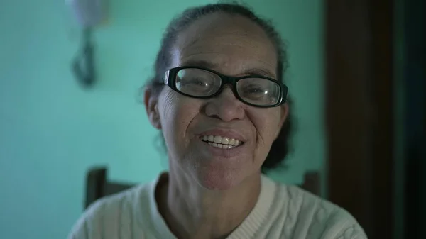A happy senior hispanic older woman smiling at camera. An older south american person portrait