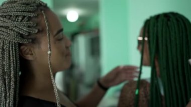 Women with box braid hairstyle. Two African American girls with braided hair