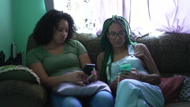 Two Young Black Latina Women Looking Phones Sitting Sofa Home — Stock video