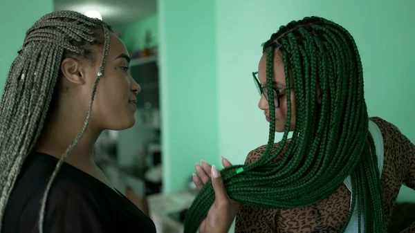 Women with box braid hairstyle. Two African American girls with braided hair