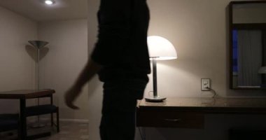 Man turns off lights before leaving apartment
