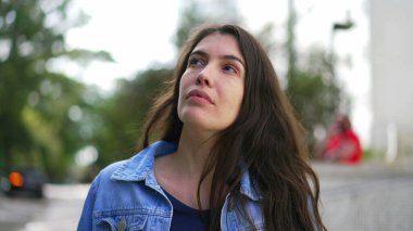 One thoughtful woman walking outside thinking. Closeup person face walks forward in contemplation