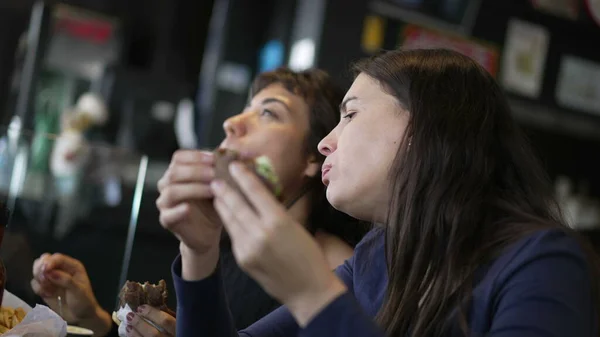 Two Young Women Eating Hamburgers People Restaurant Taking Bite Burgers — Photo