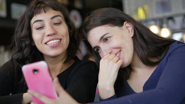 Two Young Women Looking Smartphone Device Screen Smiling Female Friends — Stok fotoğraf