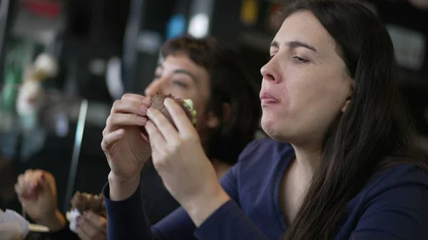 Two Young Women Eating Hamburgers People Restaurant Taking Bite Burgers — Fotografia de Stock