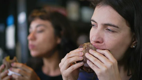 Two People Eating Burgers Young Women Taking Bite Cheeseburgers Female — Foto de Stock