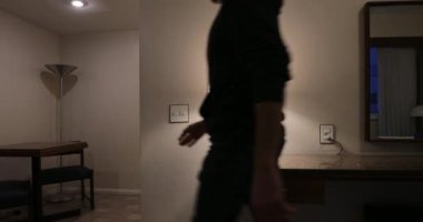 Person leaves home through front door. Bachelor exits home, turns lights OFF