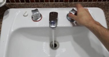 Man washing hands perspective. Point of view of person opening bathroom water focet and cleaning hands POV