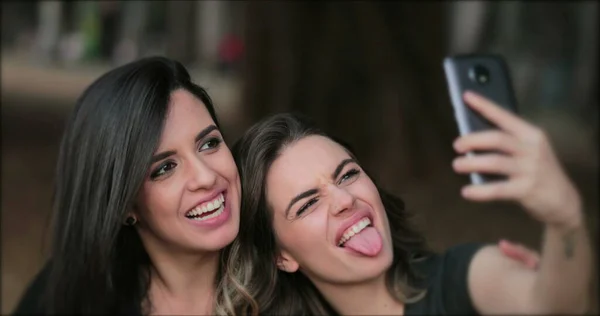 Girlfriends Taking Selfie Sticking Tongue Out Young Women Posing Photo — Stock fotografie