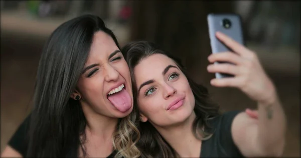 Girlfriends Taking Selfie Sticking Tongue Out Young Women Posing Photo — Stockfoto