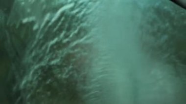 Washing car with water hose pressure in 120fps slow-motion. Cleaning windshield
