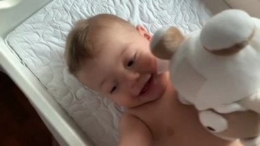 Happy baby toddler looking to camera feeling joy emotion smiling