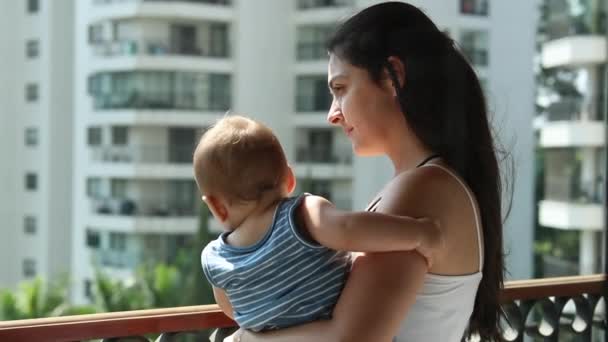 Candid Casual Mother Holding Baby Son Balcony Seen Window — Wideo stockowe