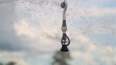 Pivot irrigation system. 120fps slow-motion close-up of pivot sprinkler system irrigating crops. Irrigation pivot system watering agriculture field
