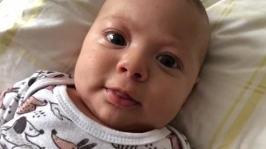 Baby infant at bed at home casual and authentic