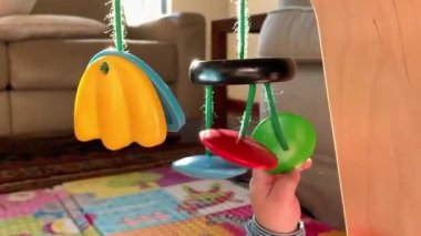 Baby hands playing with wooden toy