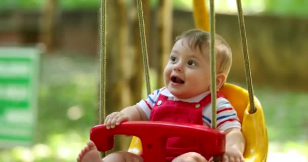 Mom Pushing Baby Boy Playground Park Swing Having Fun Enjoying — Stockvideo