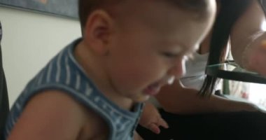 Mom feeding upset baby boy infant