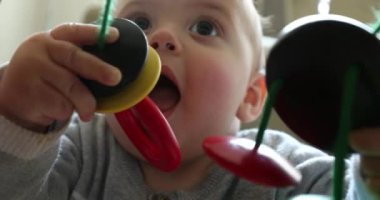 Cute baby playing grabbing arch toy learning exploring about the world