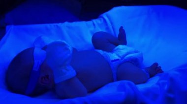 Newborn baby first day of life at phototherapy