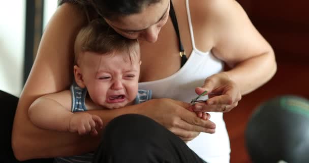 Mother Cutting Upset Baby Son Nails — Stock Video