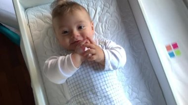 Adorable cute baby infant boy looking to camera blond boy