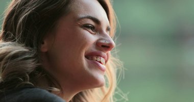 Young woman spontaneous real life laugh. Authentic candid girl acting bashful and flirtatious