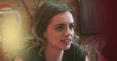 Night scene of Candid casual young women talking to friend off-camera