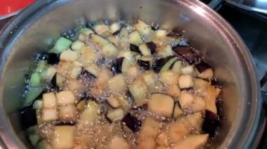 Closeup of boiling vegetables inside pan