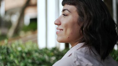 Sokakta yürüyen Latin bir Latin kızın sırtında. Genç bir kadın kaldırımda yürüyor